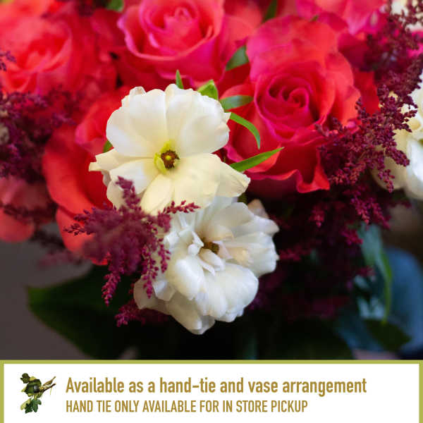 Bouquet of pink roses and white flowers with burgundy filler