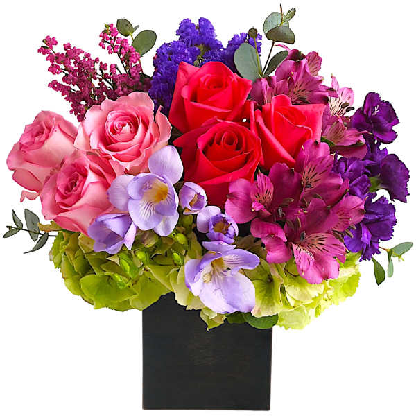 Colorful bouquet of roses, orchids, and hydrangeas in a black vase