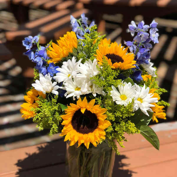 Sunflower and daisy bouquet in a glass vase