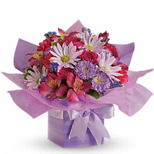 Compact bouquet of pink and lavender flowers in a lavender gift box with matching ribbon