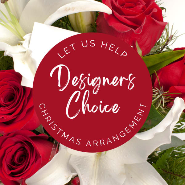 Red roses and white lilies with a Christmas arrangement label