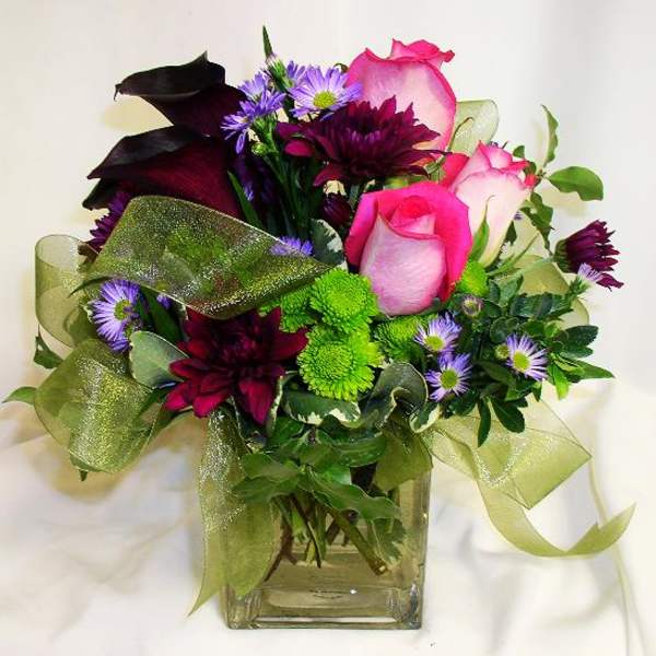 Bouquet of pink and purple flowers in a clear glass vase