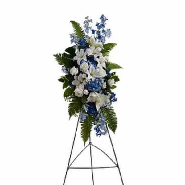 Tall blue and white floral standing spray on an easel