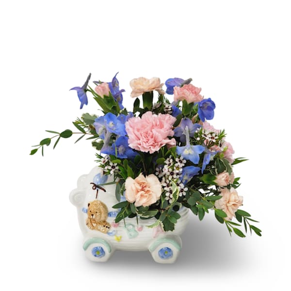 Pink and blue flowers arranged in a decorative ceramic cart