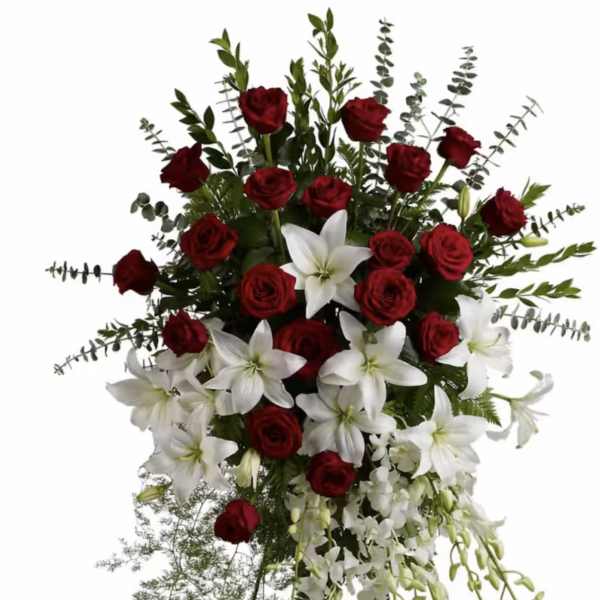 Standing floral spray with red roses and white lilies on a metal easel