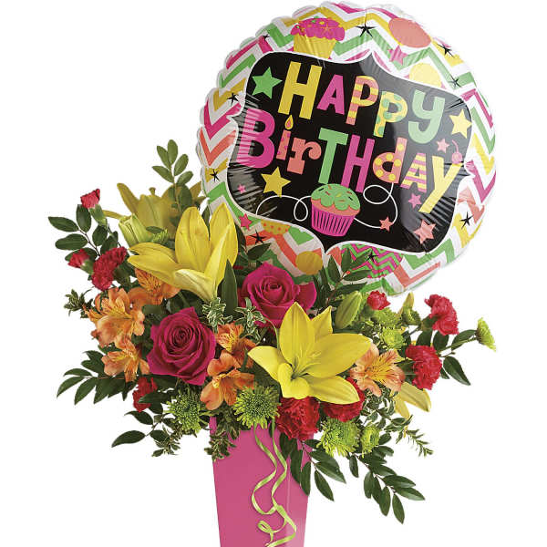 Birthday balloon above a colorful flower arrangement in a pink vase