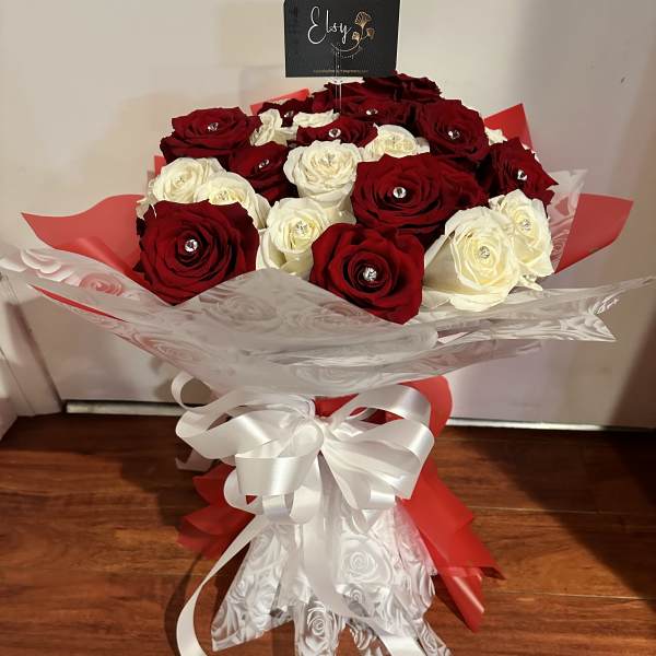 Bouquet of red and white roses wrapped with a white ribbon