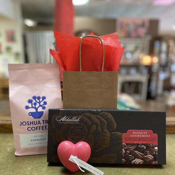 Gift set with coffee, chocolates, and a heart-shaped rose tag