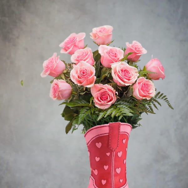 Pink roses arranged in a pink cowboy boot vase