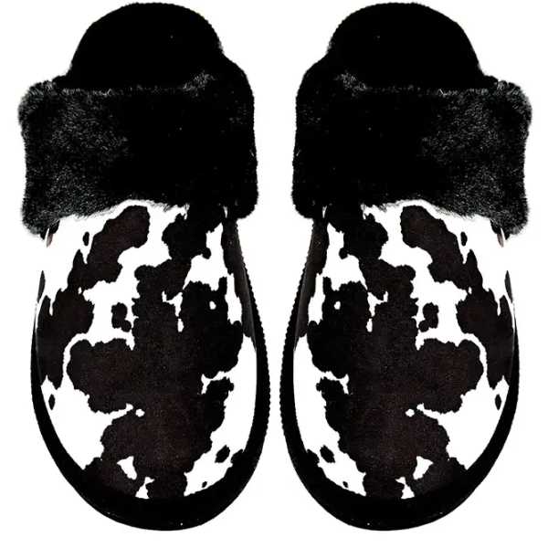 Pair of black-and-white cow-print slippers with fuzzy cuffs