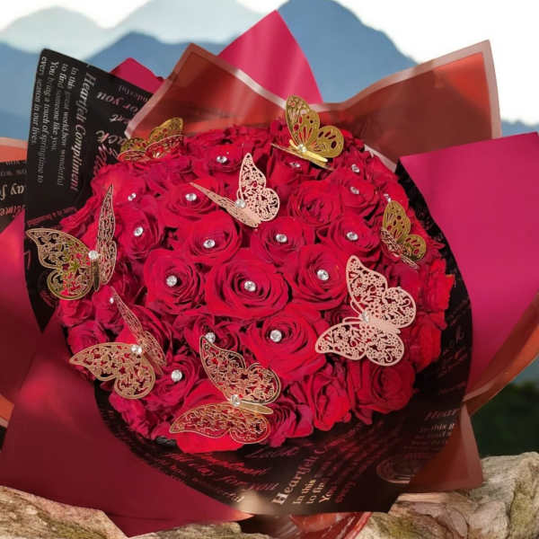Bouquet of red roses wrapped in dark paper with butterfly decorations