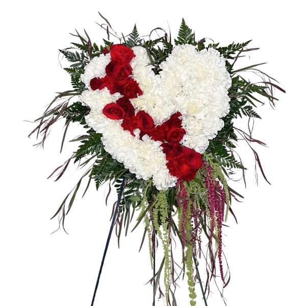 Heart-shaped red and white floral standing spray on an easel