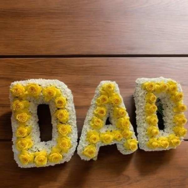 Yellow and white floral letters spelling DAD