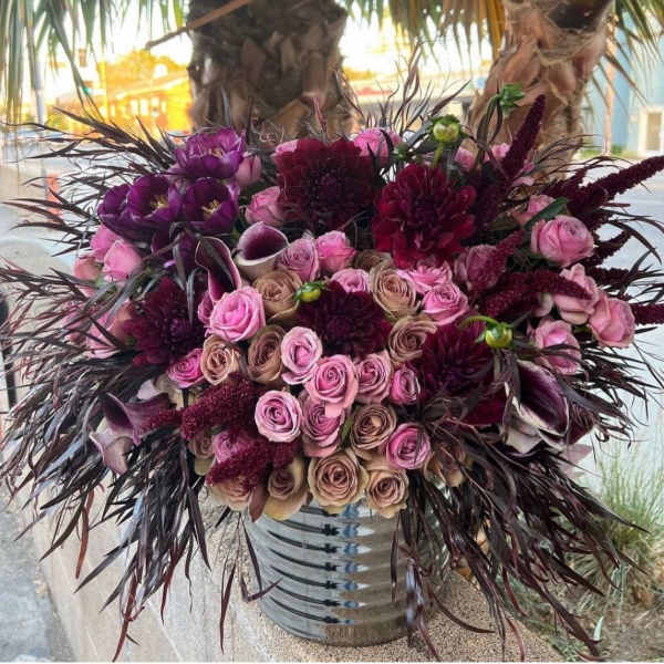 Bouquet of pink and burgundy flowers in a metal vase