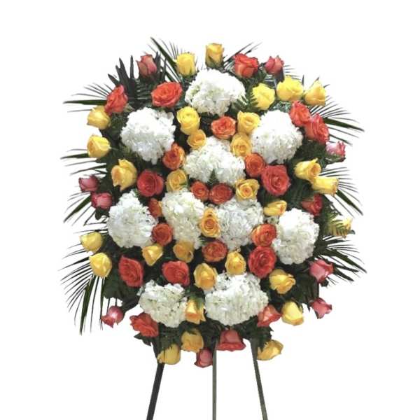 Standing floral wreath of roses and white blooms on an easel