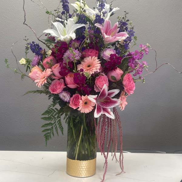 Pink and white mixed bouquet in a gold vase