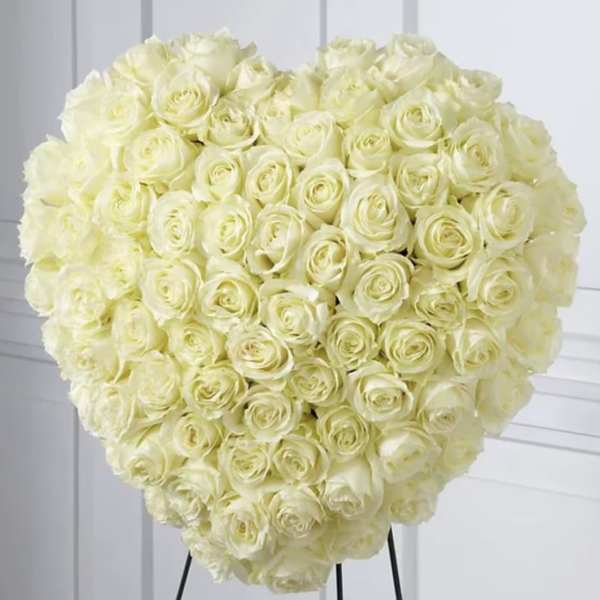Large heart-shaped bouquet of cream roses on a stand