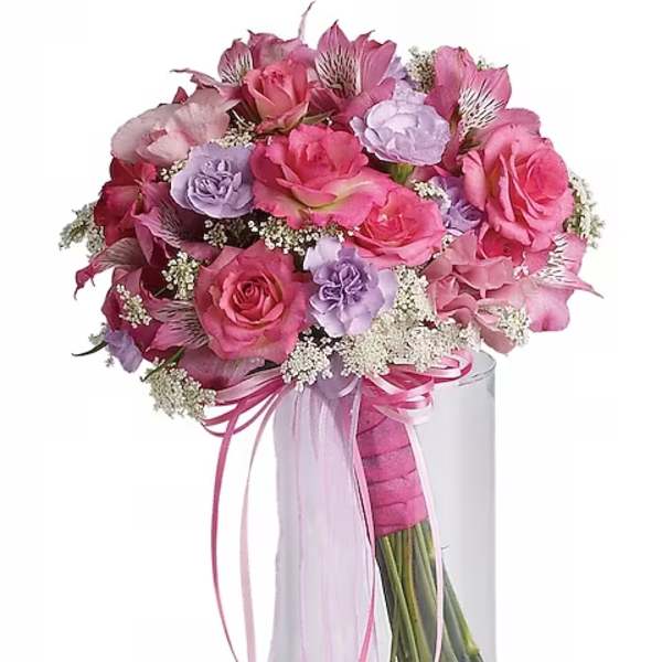 Pink and lavender rose bouquet in a clear glass vase with ribbon