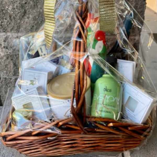 Gift basket wrapped in clear cellophane with ribbon and assorted bath items