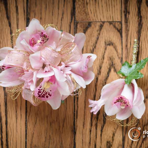 Pink orchid corsage and boutonniere with ribbon accents