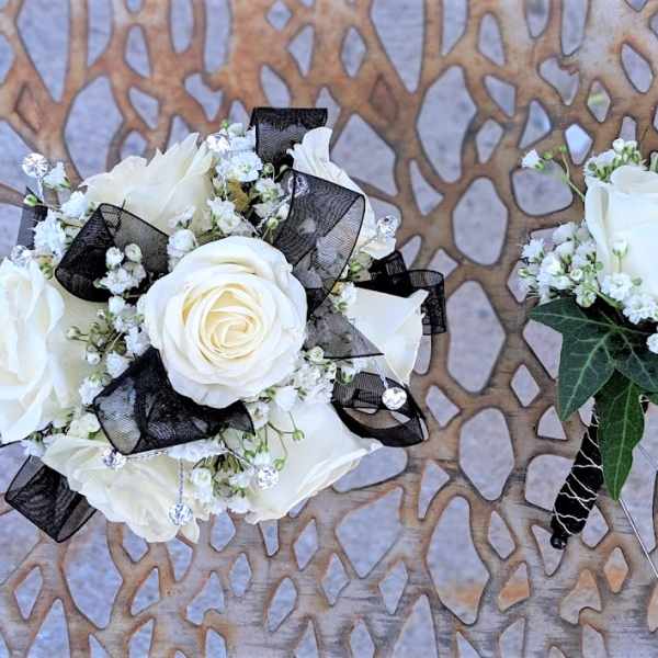 White rose boutonniere and matching wrist corsage with black ribbon