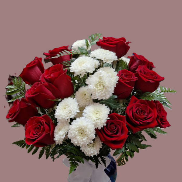 Arrangement of red roses and white mums in a blue vase with a white bow