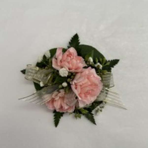 Pink rose corsage with white accents and ribbon