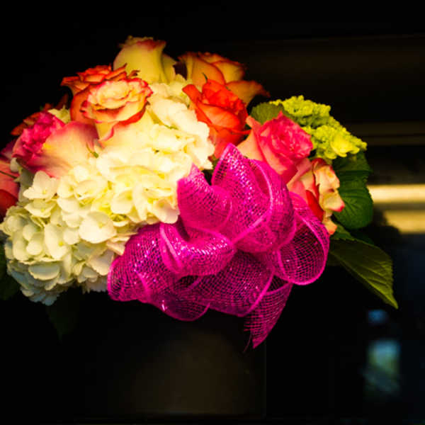 Bouquet of roses and hydrangeas with a bright pink ribbon
