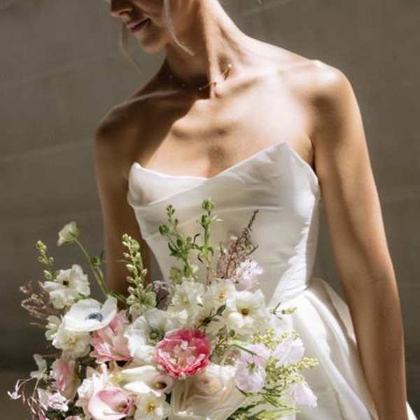 Bride holding a pastel bouquet with white and pink flowers