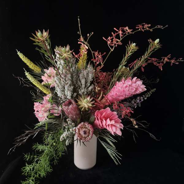Pink and white floral arrangement in a white vase