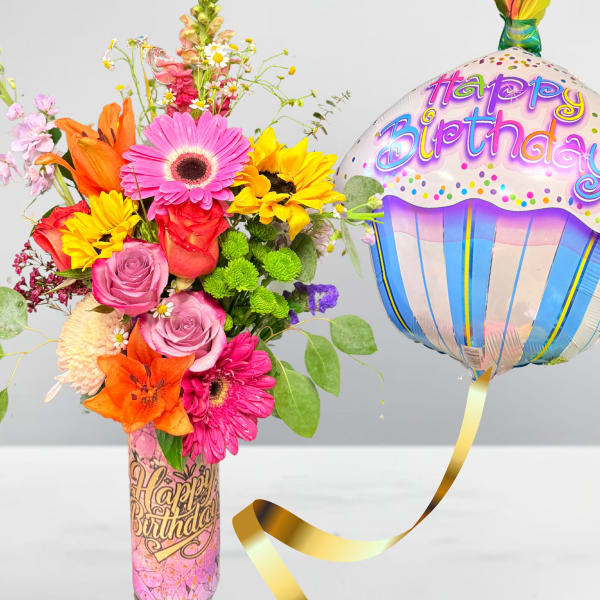 Colorful mixed flower bouquet with a birthday balloon in a decorated vase