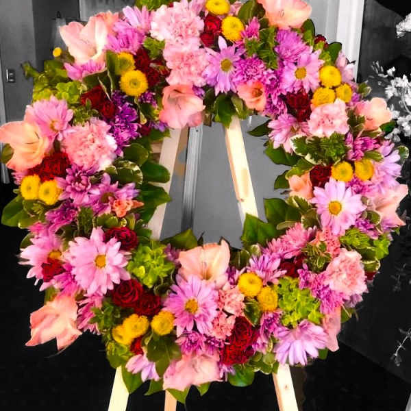 Heart-shaped floral wreath with pink, purple, yellow, and red blooms
