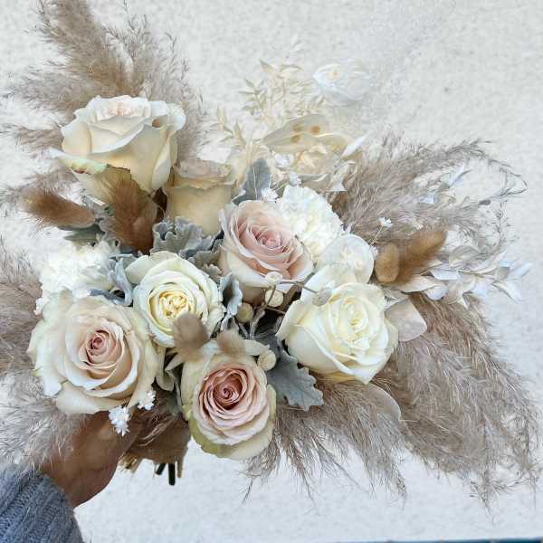 Bouquet of cream and blush roses with dried pampas grass