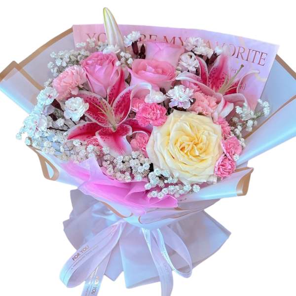 Bouquet of pink and cream roses with lilies and small white filler flowers