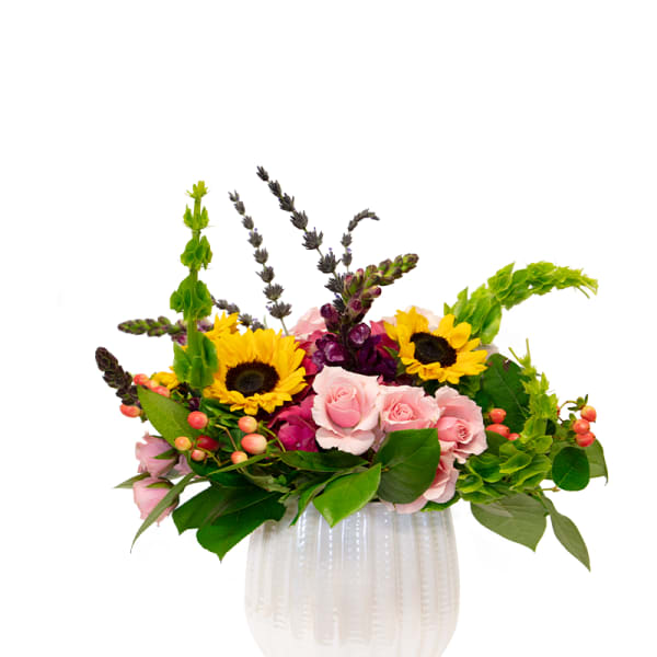 Pink roses and sunflowers in a white vase