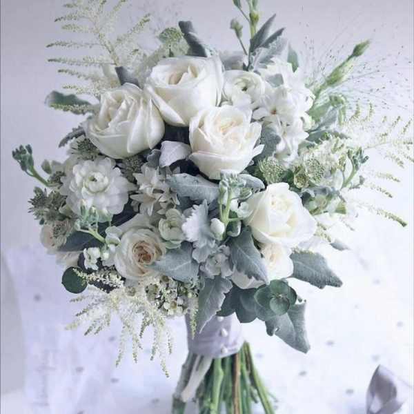 White rose bouquet with silvery foliage and a ribbon wrap