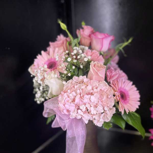 Pink bouquet with roses, hydrangea, and gerbera daisies in a vase