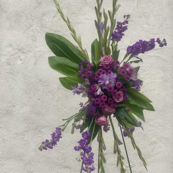 Tall purple floral spray with roses and long stems
