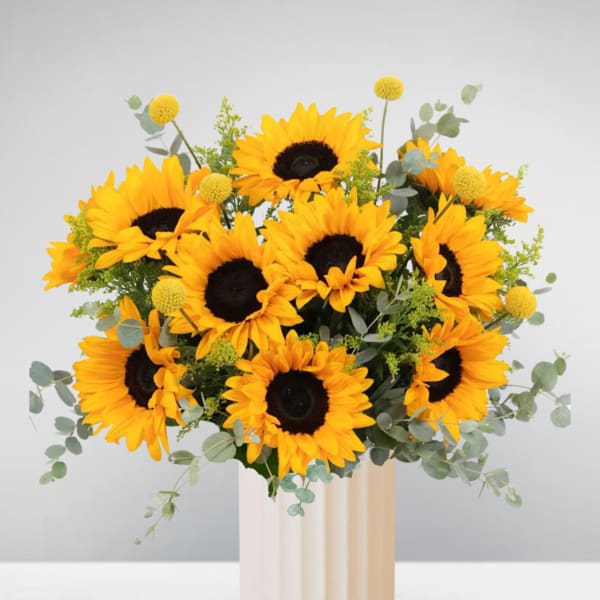 Bouquet of sunflowers in a tall cream vase