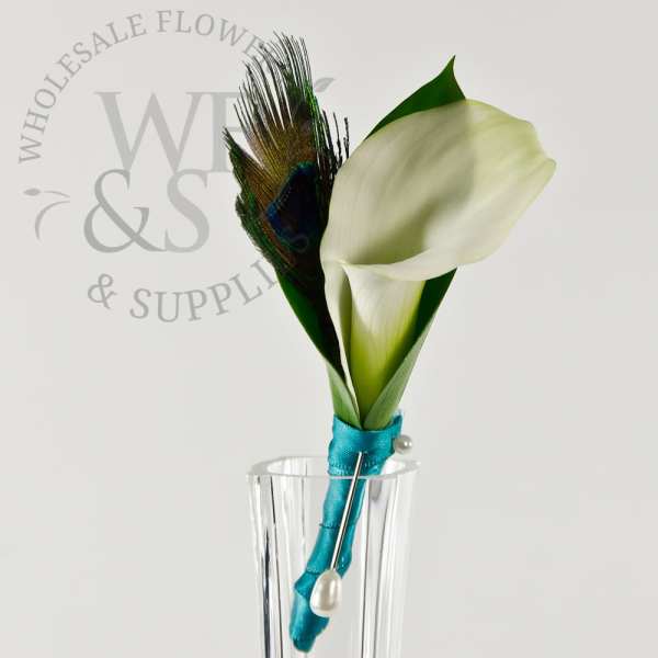 White calla lily boutonniere with peacock feather in a clear holder