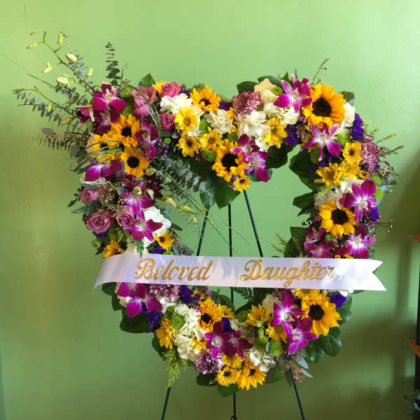Heart-shaped floral wreath with a "Beloved Daughter" ribbon