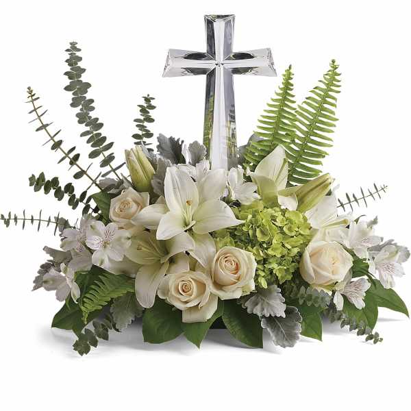 White floral arrangement with a silver cross centerpiece