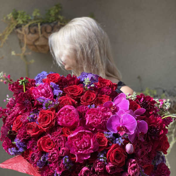 Large bouquet of red and pink roses with purple orchids