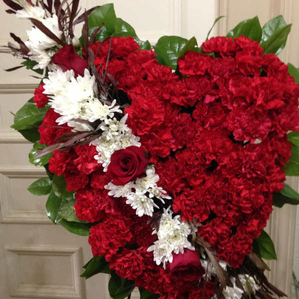 Heart-shaped red floral spray with white accents and roses