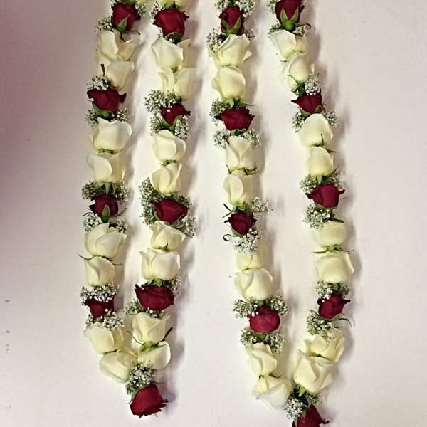 Four floral garlands with red and white roses and pearl loops
