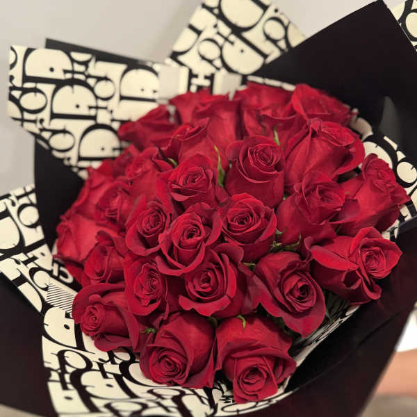 Bouquet of red roses wrapped in black and white paper