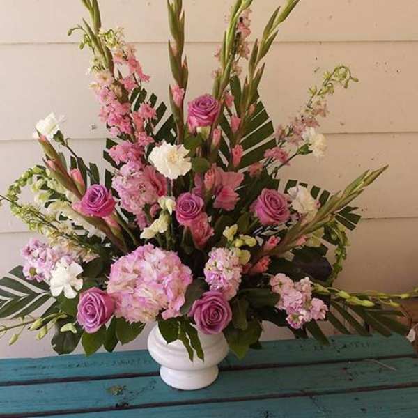 Pink and white floral arrangement in a white vase