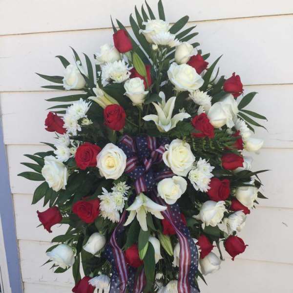 Standing wreath of red and white roses with patriotic ribbon