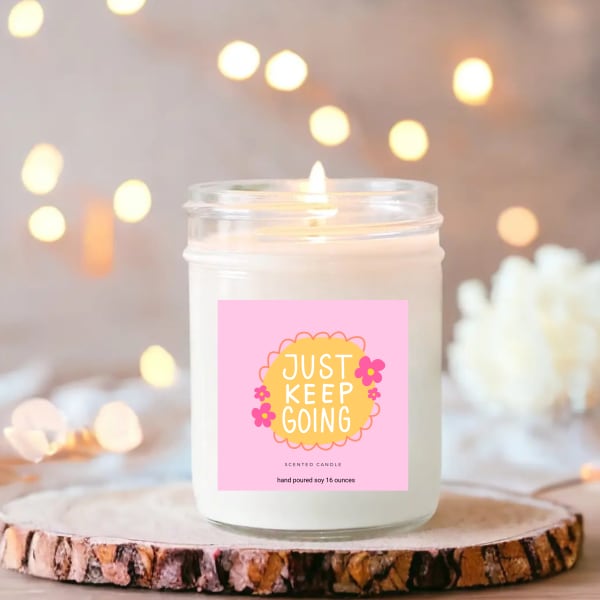 Scented candle in a glass jar with a pink label