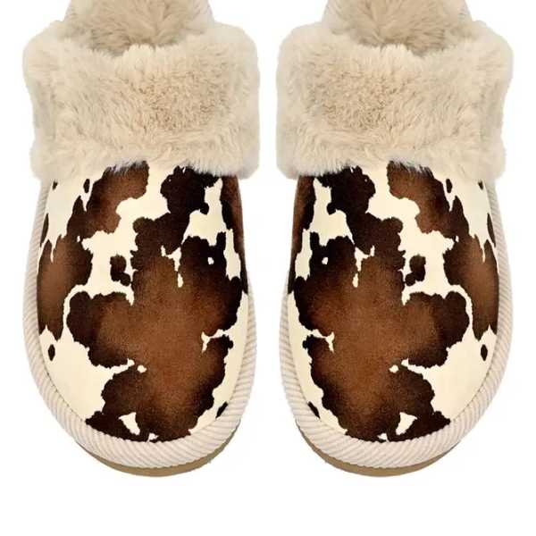 Pair of fuzzy cow-print slippers with cream faux-fur cuffs